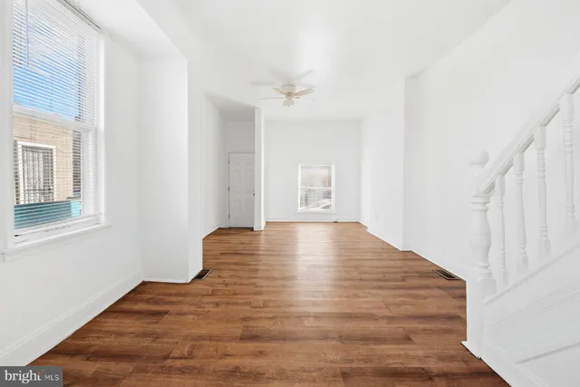 a view of room with window and wooden floor