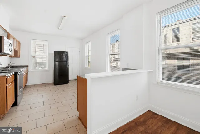 a kitchen with stainless steel appliances a refrigerator and a stove