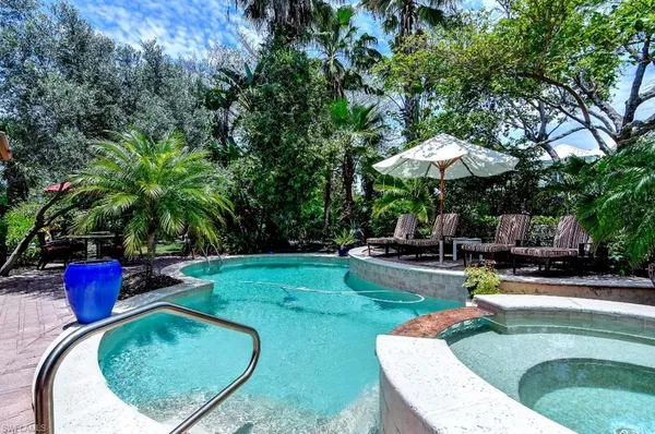 swimming pool view with a seating space
