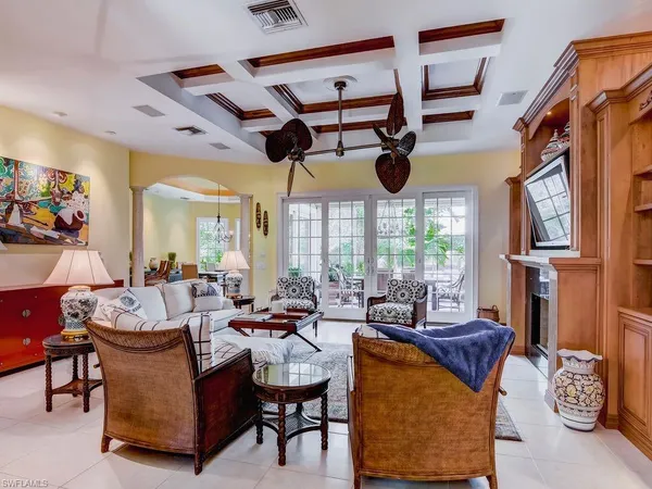 a living room with fireplace furniture and a large window