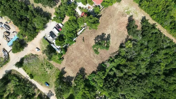 an aerial view of a house with a yard and plants