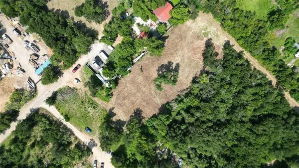 an aerial view of a house with a yard and plants