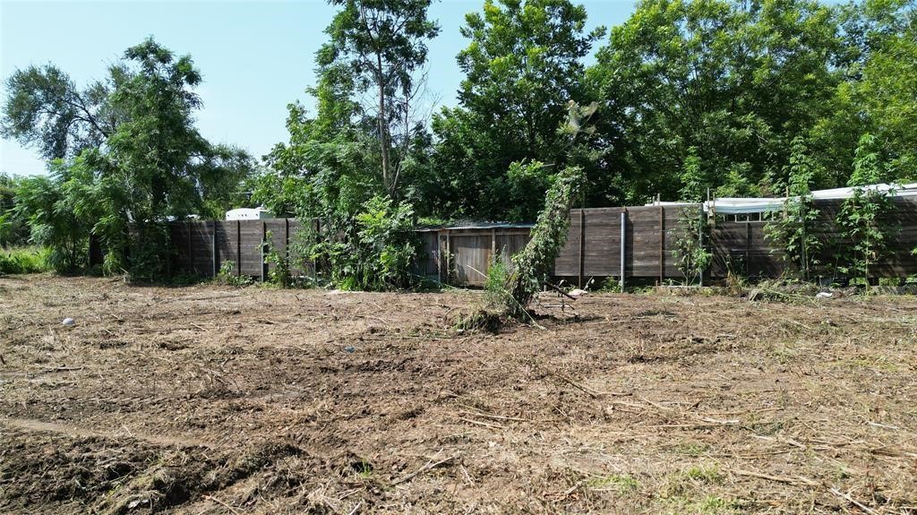 Tbd Arthur Street Elgin, TX 78621 - Photo 9 of 15 a view of a backyard with a small cabin and a chair