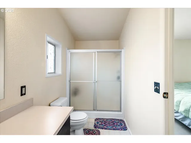 a bathroom with a toilet and a shower