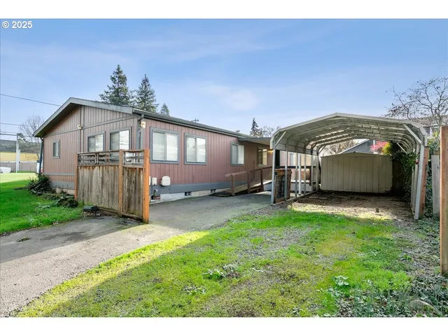 a front view of a house with a garden and yard