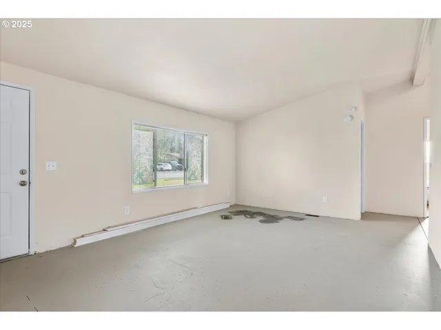 a view of an empty room with a window