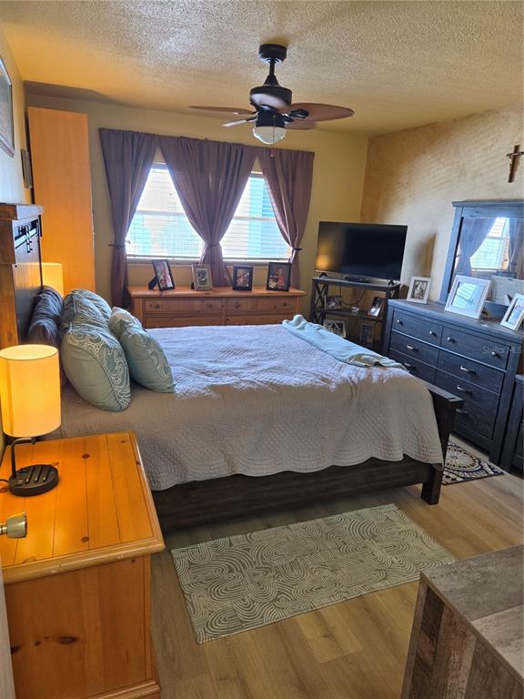 7 Dunoon Place, Unit 309 Dunedin, FL 34698 - Photo 19 of 25 a bedroom with a bed and wooden floor
