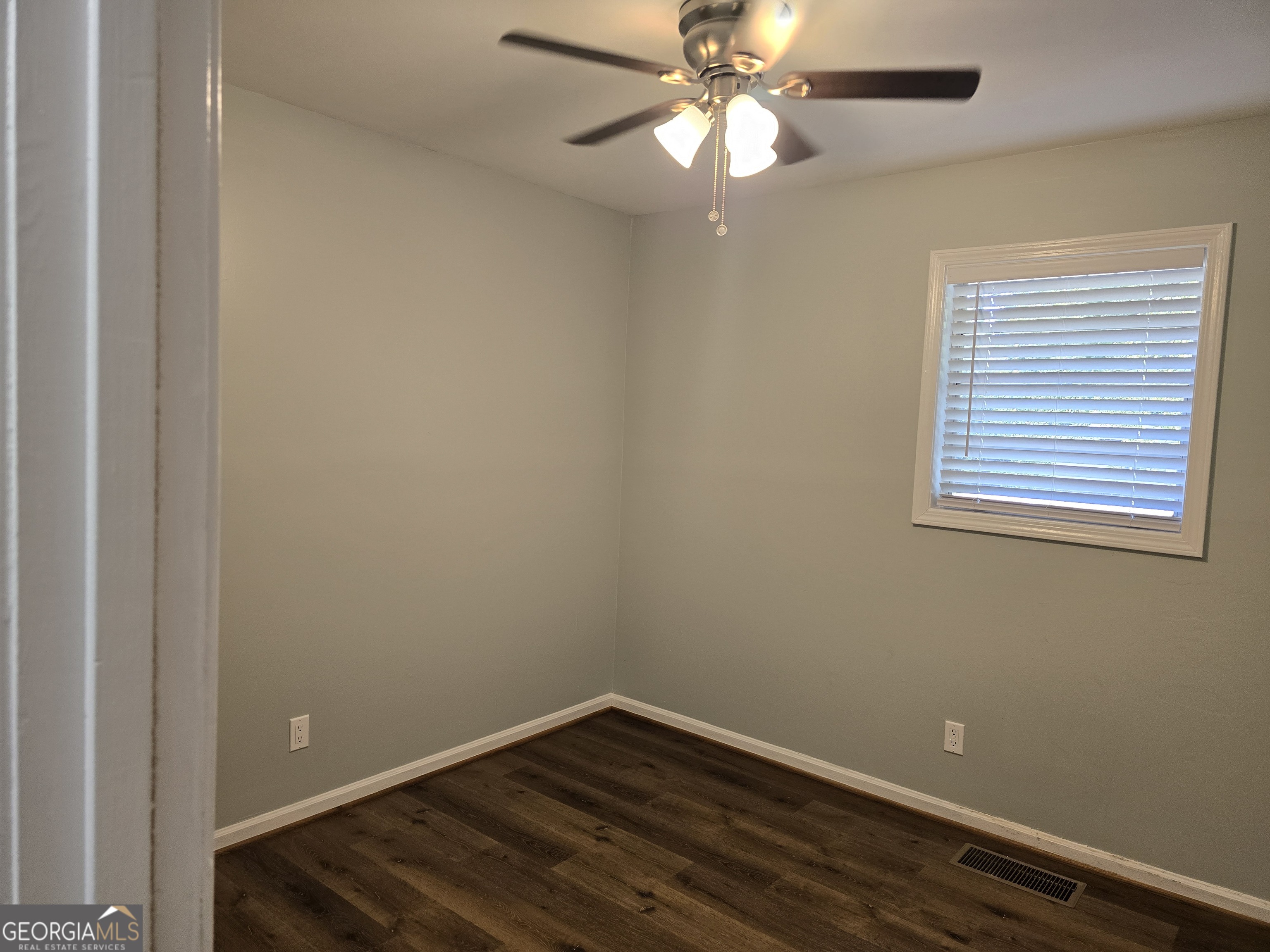 205 Emory Way Oxford, GA 30054 - Photo 13 of 18 an empty room with wooden floor closet fan and windows