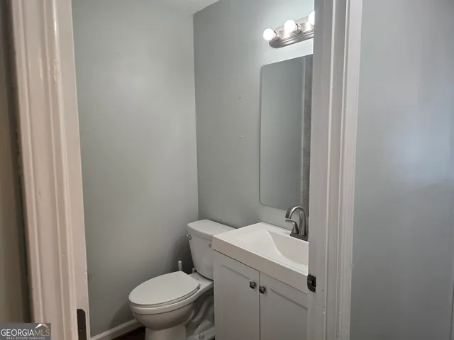 a bathroom with a toilet a sink and mirror