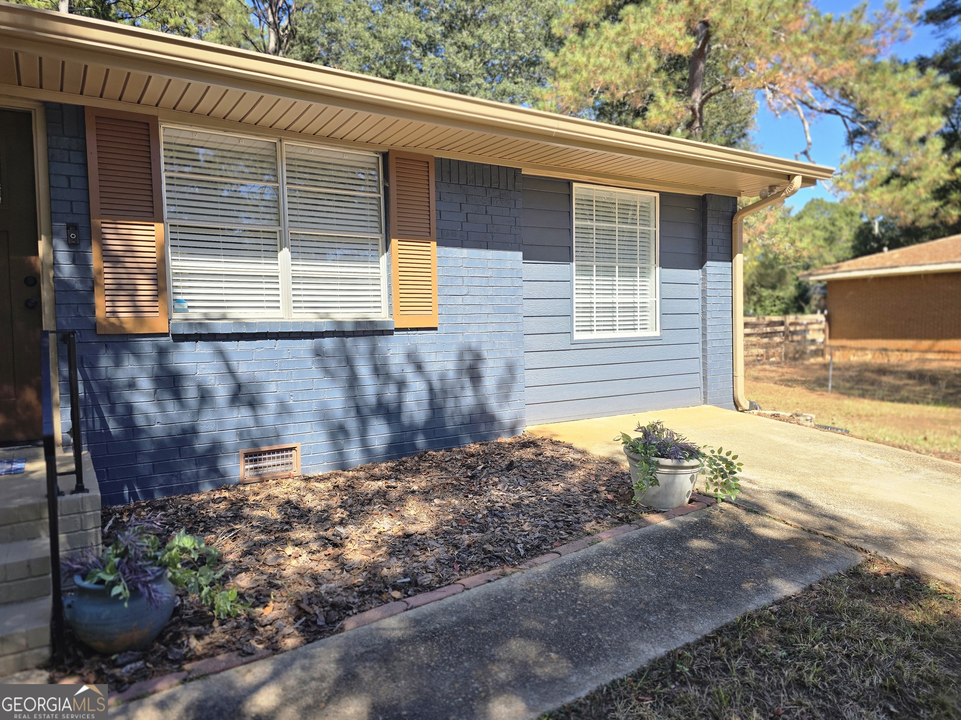 205 Emory Way Oxford, GA 30054 - Photo 4 of 18 a view of a backyard with plants and large tree