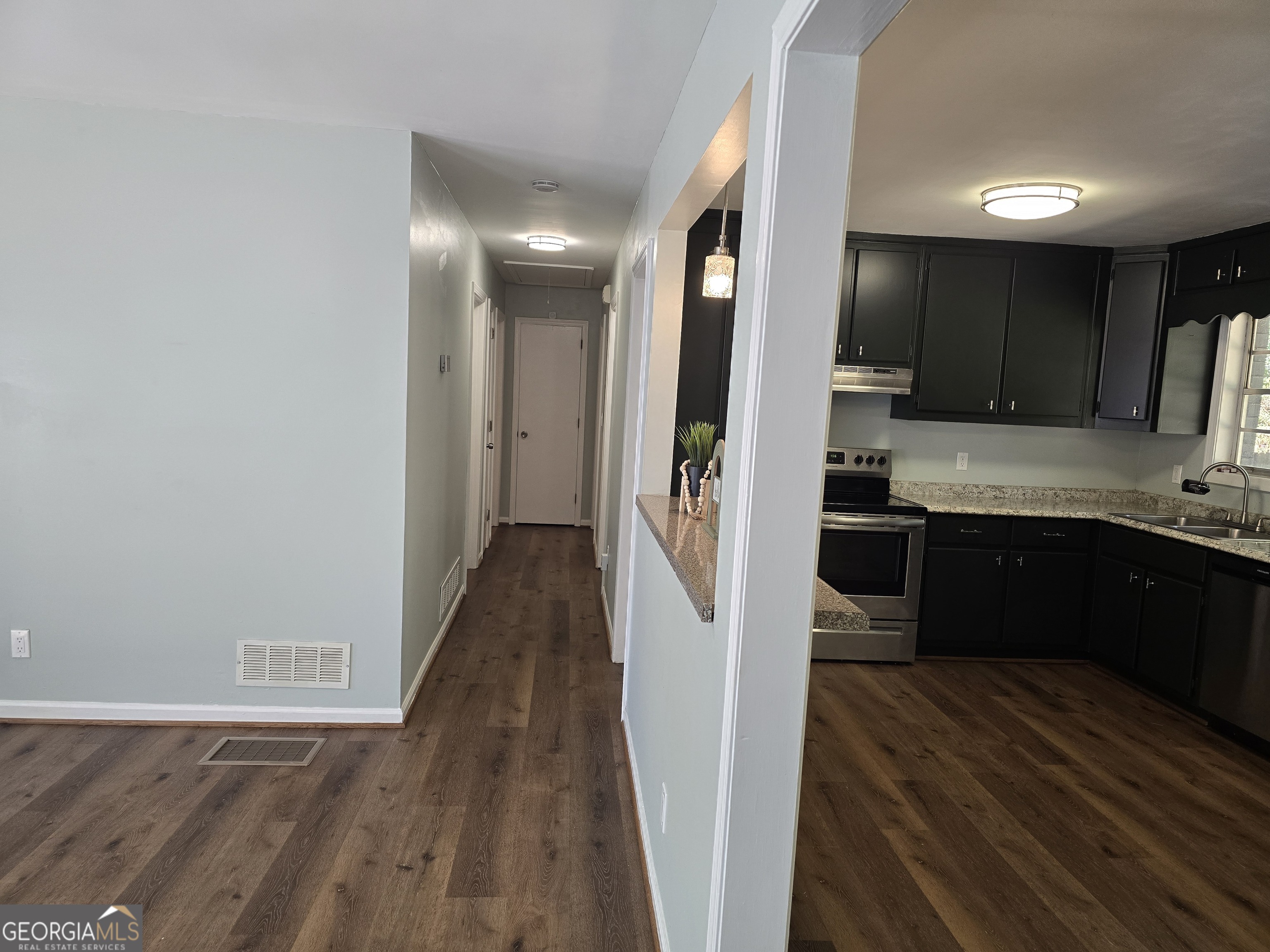 205 Emory Way Oxford, GA 30054 - Photo 9 of 18 a kitchen with a refrigerator and a sink