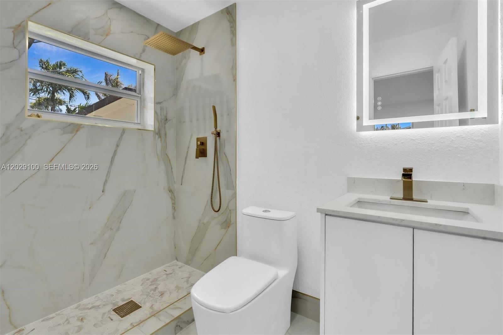 11790 Southwest 34th Street Miami, FL 33175 - Photo 39 of 56 a white toilet sitting next to a bathroom sink