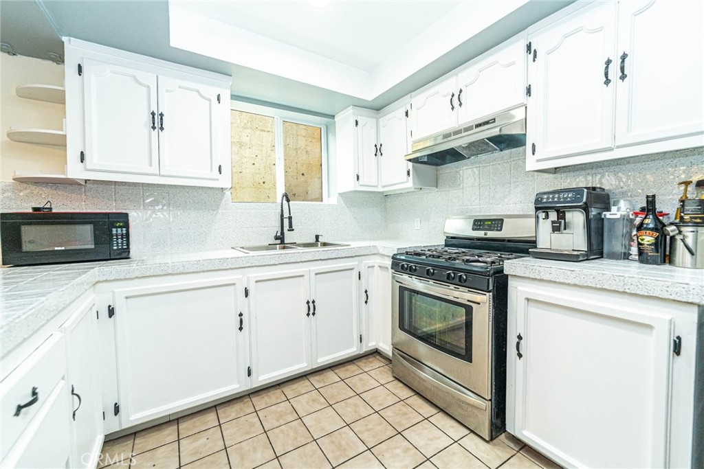 10334 Big Tujunga Canyon Road Tujunga, CA 91042 - Photo 13 of 39 a kitchen with cabinets stainless steel appliances and a sink