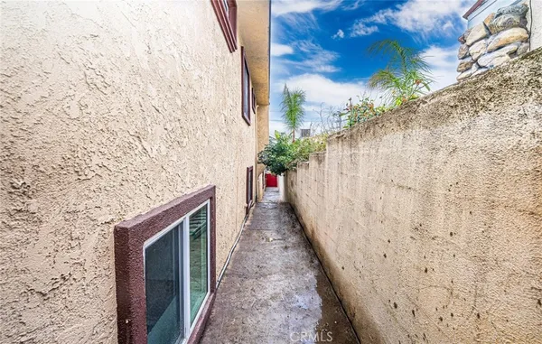 a view of a pathway along with potted plants
