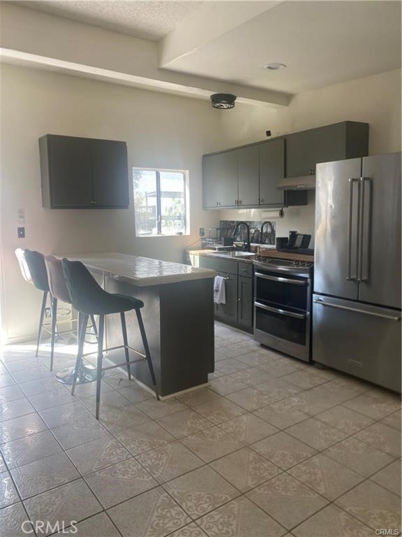 10334 Big Tujunga Canyon Road Tujunga, CA 91042 - Photo 7 of 39 a kitchen with stainless steel appliances granite countertop a stove top oven microwave and a refrigerator