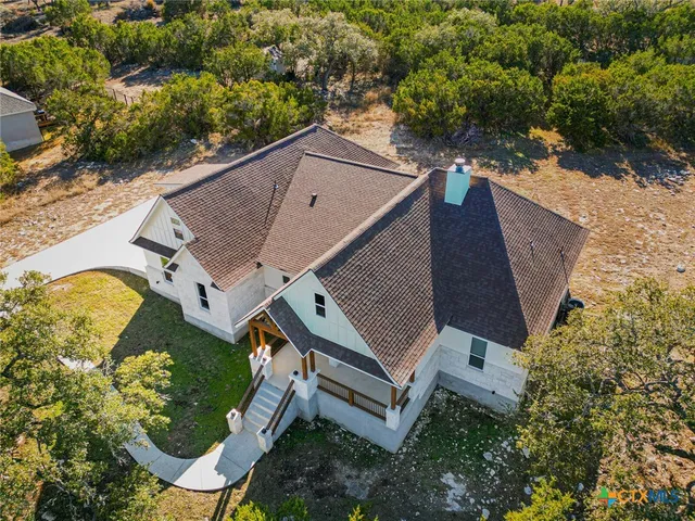 a aerial view of a house with a yard and sitting area
