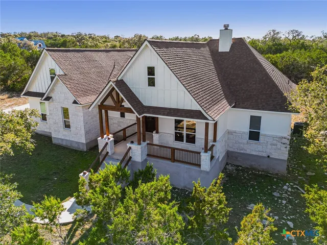 an aerial view of a house with a yard