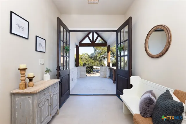 a spacious bedroom with a bed and a large window