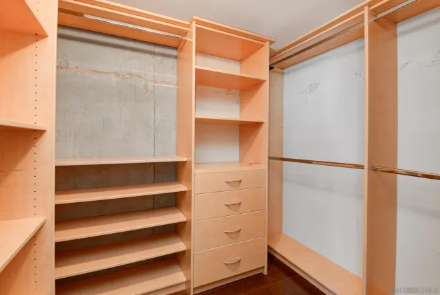 a view of walk in closet with empty racks