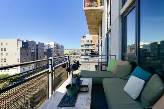 a balcony with furniture and a city view