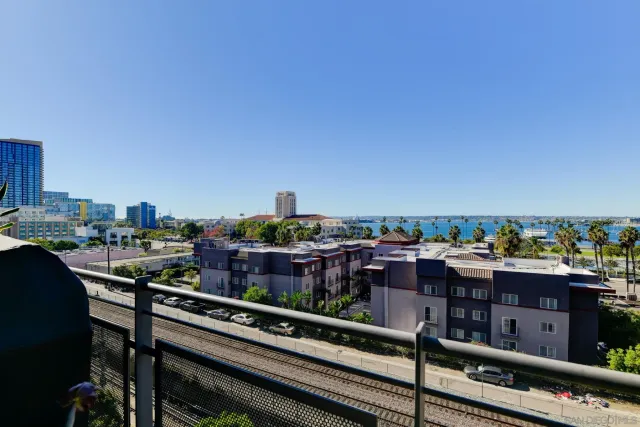 a view of a balcony with wooden benches