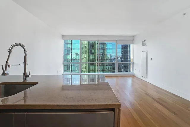 a kitchen with kitchen island a sink and wooden floor