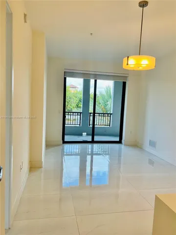 a view of a room with a sink and a chandelier