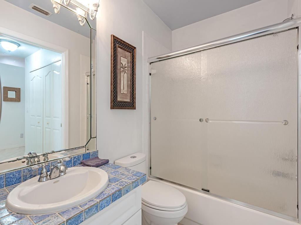 472 St Andrews Boulevard Naples, FL 34113 - Photo 16 of 18 a bathroom with a sink and a mirror