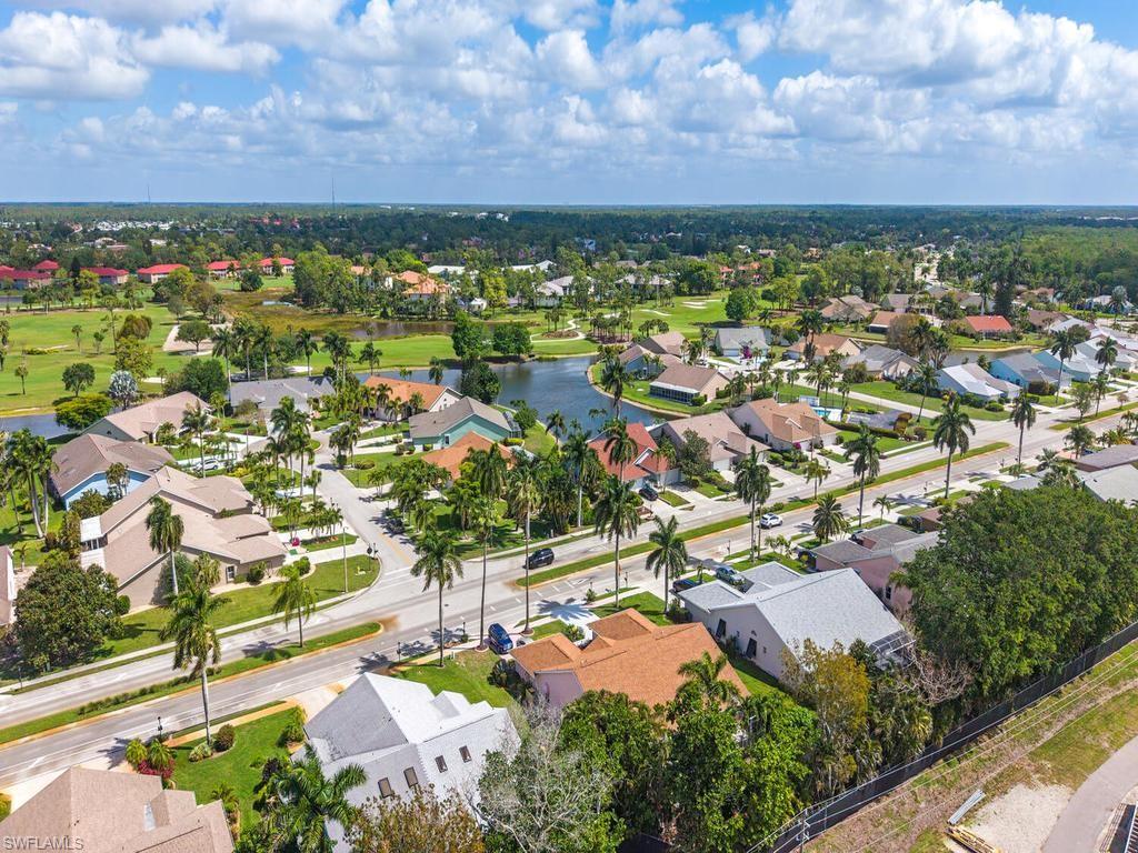 472 St Andrews Boulevard Naples, FL 34113 - Photo 5 of 18 an aerial view of residential houses with outdoor space and trees