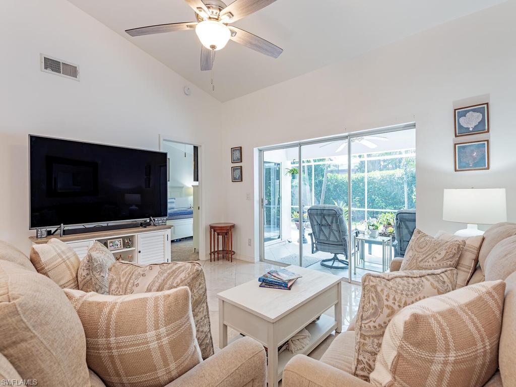 472 St Andrews Boulevard Naples, FL 34113 - Photo 9 of 18 a living room with furniture and a flat screen tv