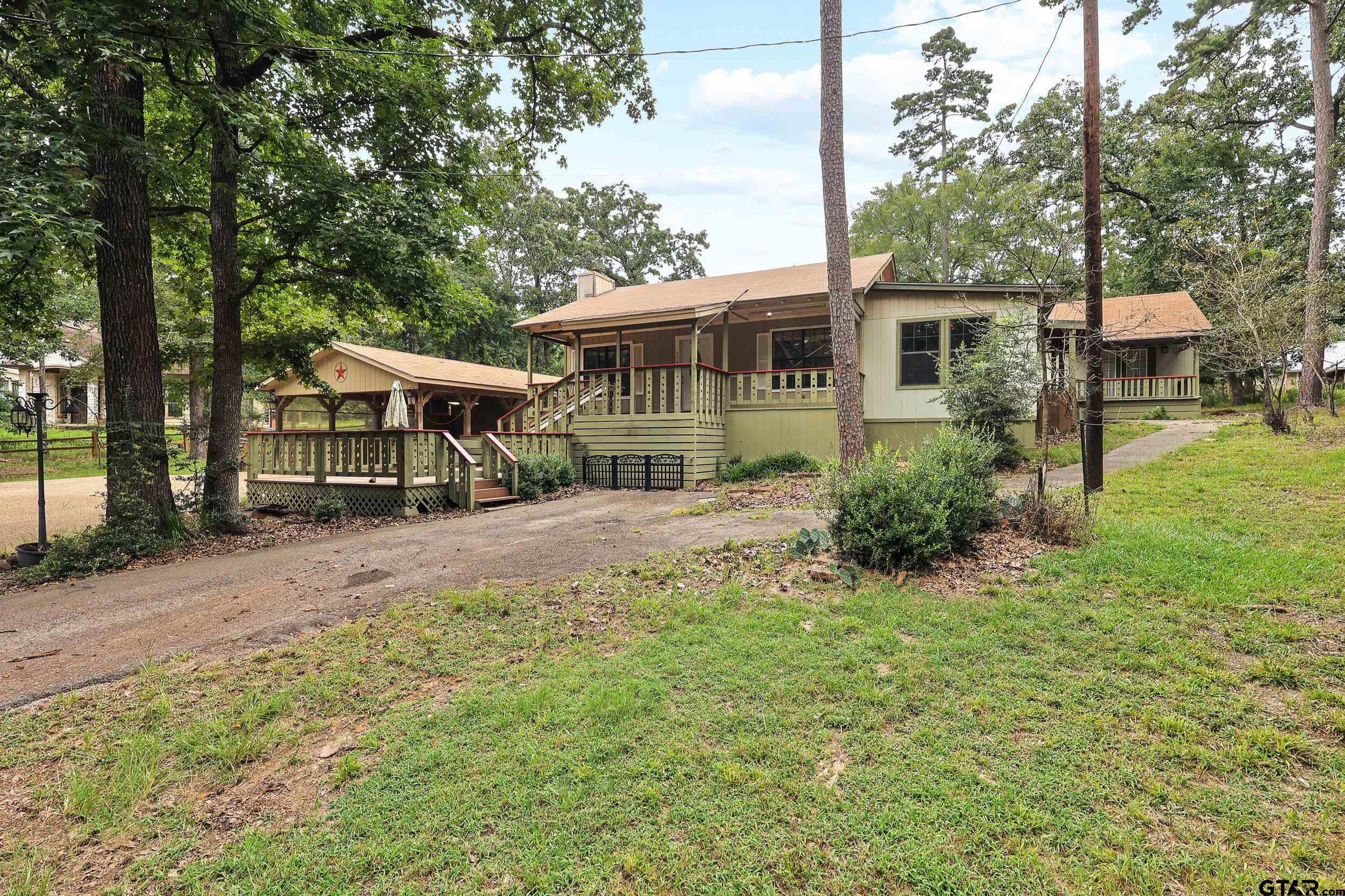 a view of a house with backyard and sitting area