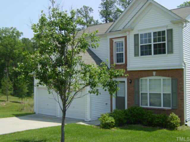 204 Willingham Road Morrisville, NC 27560 - Photo 1 of 10 a tree in front of a house next to a yard