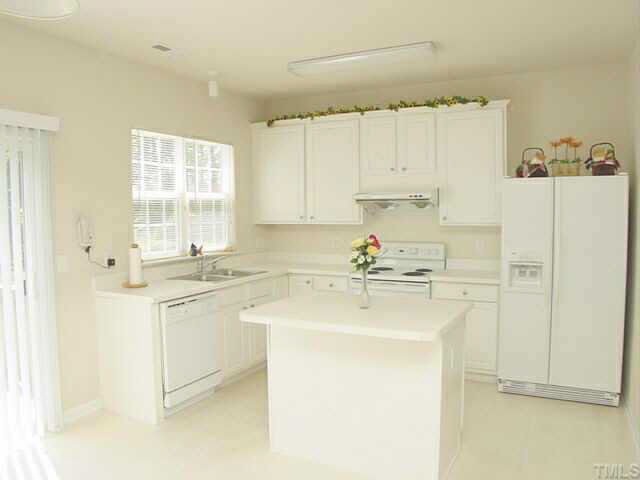 204 Willingham Road Morrisville, NC 27560 - Photo 4 of 10 a kitchen with a sink cabinets appliances and a window