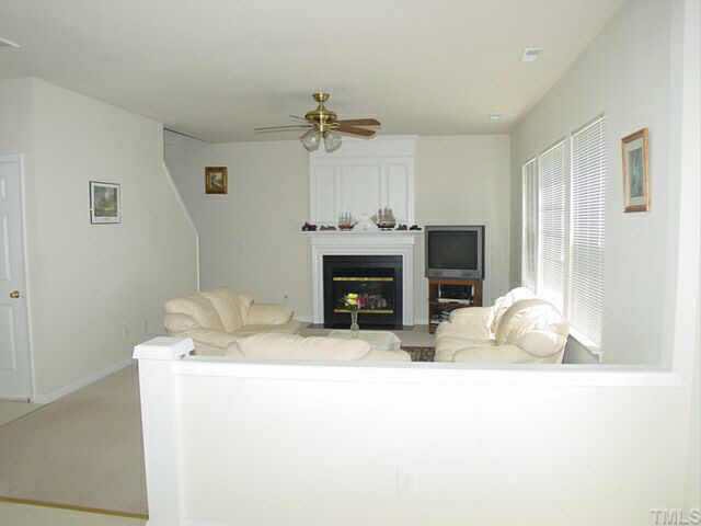 204 Willingham Road Morrisville, NC 27560 - Photo 5 of 10 a room with furniture a fireplace and a flat screen tv