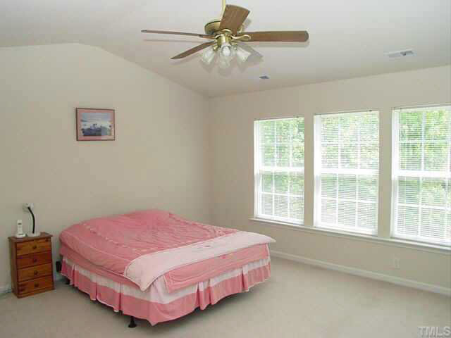 204 Willingham Road Morrisville, NC 27560 - Photo 7 of 10 a bedroom with a bed and a chandelier