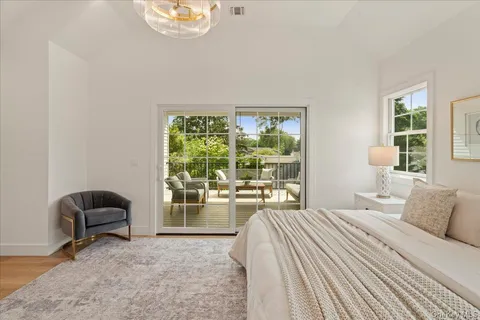 a bedroom with a bed and a chair