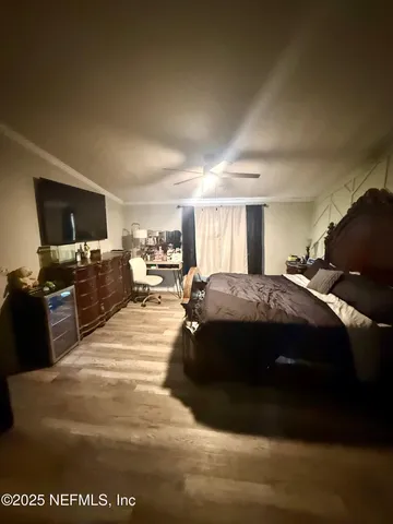 a spacious bedroom with a bed and a television in it