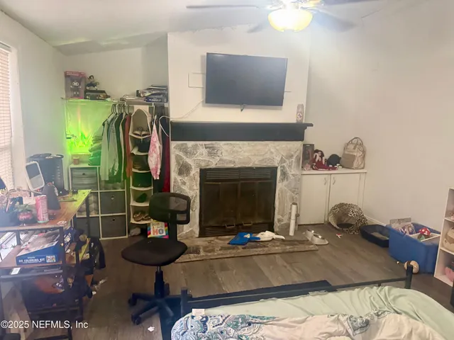 a living room with furniture a flat screen tv and a fireplace