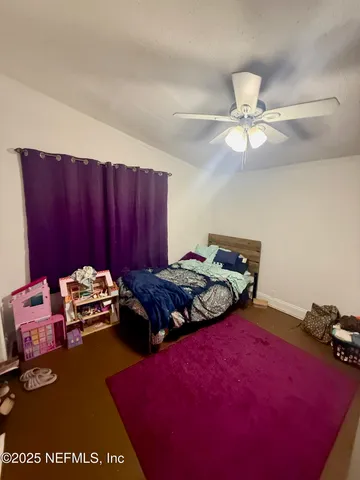 a bedroom with a bed and a mirror