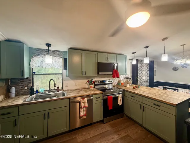 a kitchen with a sink and a stove top oven