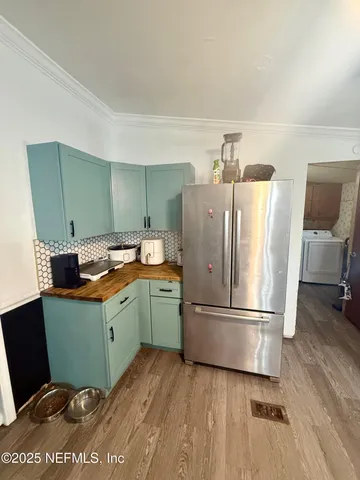 a kitchen with a refrigerator and a sink