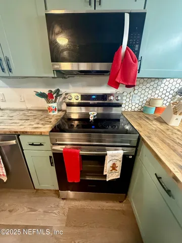 a stove top oven sitting inside of a kitchen
