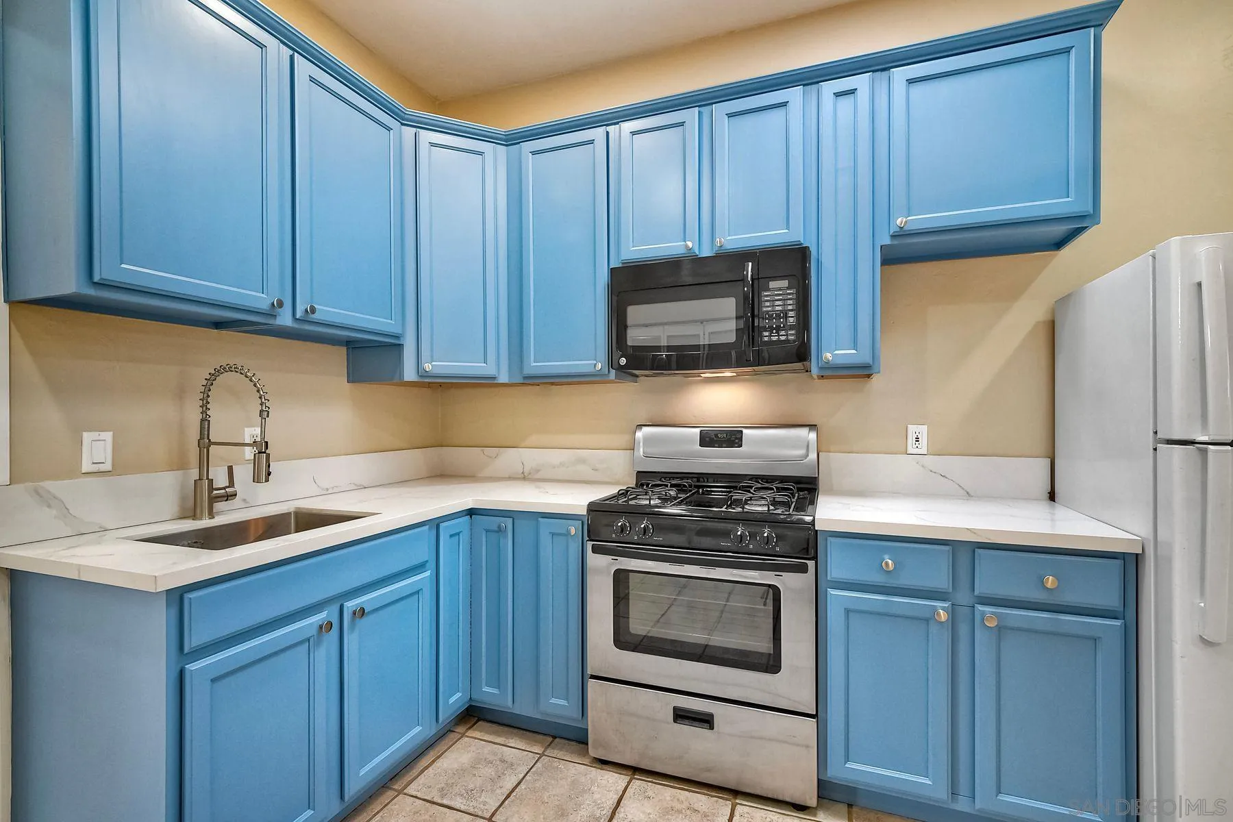 602 South Grape Street, Unit A Escondido, CA 92025 - Photo 11 of 31 a kitchen with cabinets stainless steel appliances a sink and wooden cabinets