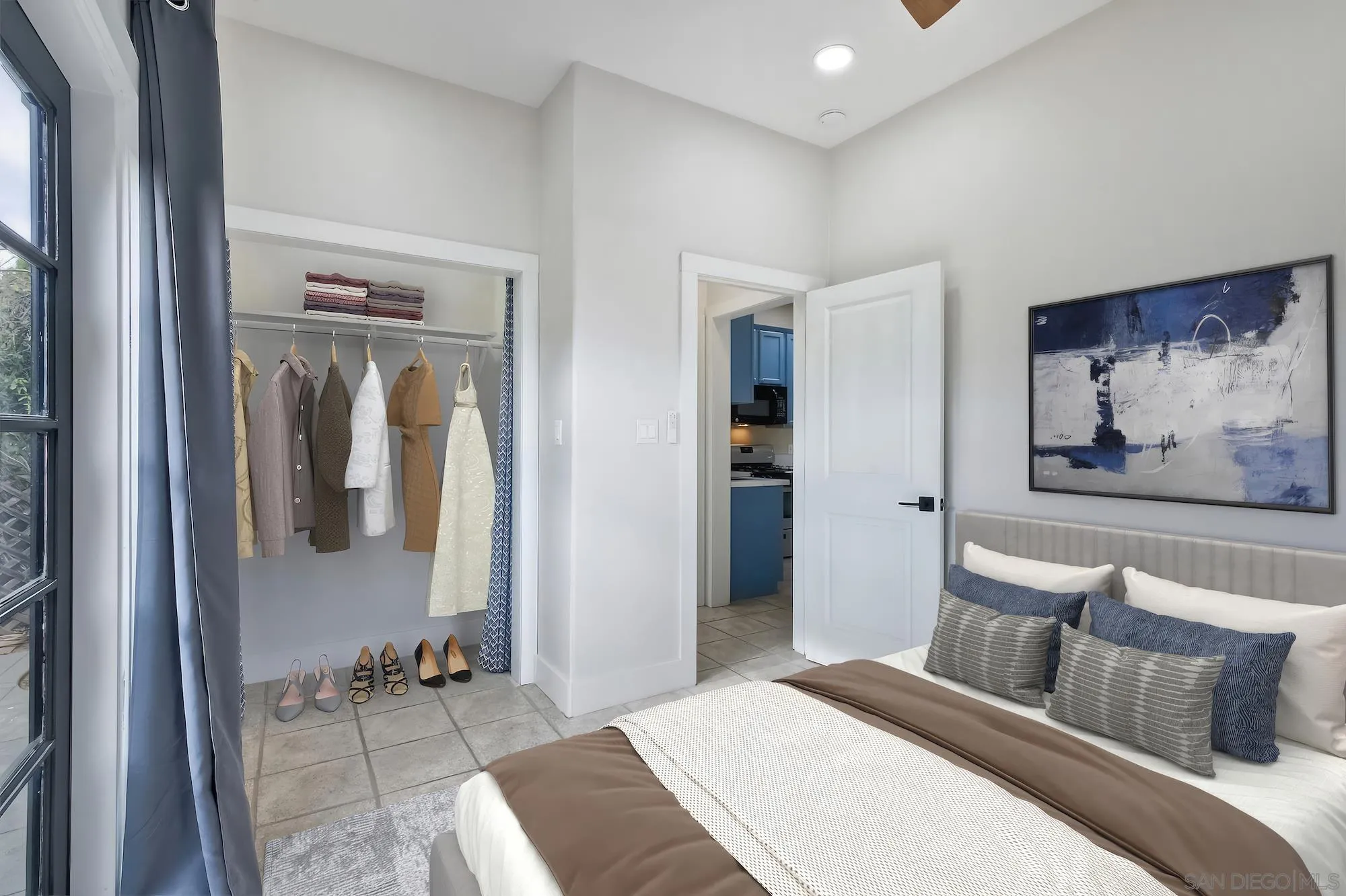 602 South Grape Street, Unit A Escondido, CA 92025 - Photo 14 of 31 a bedroom with a bed and glass wall painting