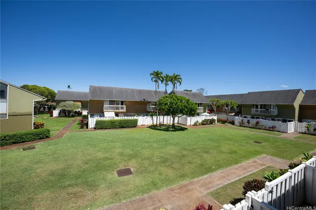 a view of a house with backyard and sitting area