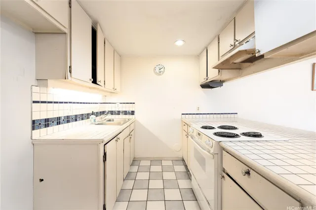 a kitchen with a sink stove and cabinets