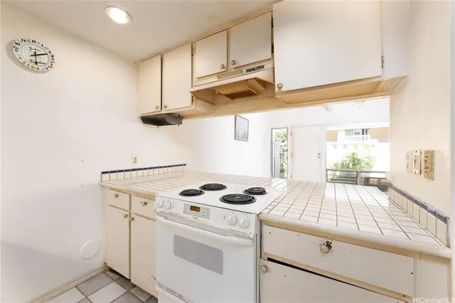 a kitchen with white cabinets and white appliances
