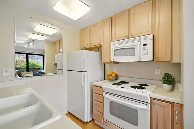 a kitchen with a refrigerator a stove a washer and dryer