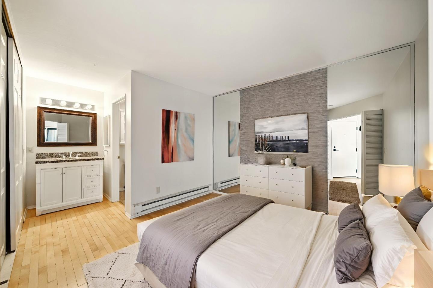 125 Surf Way, Unit 343 Monterey, CA 93940 - Photo 4 of 8 a bedroom with a bed and a flat screen tv