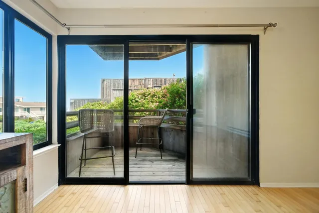 a view of a glass door and the balcony